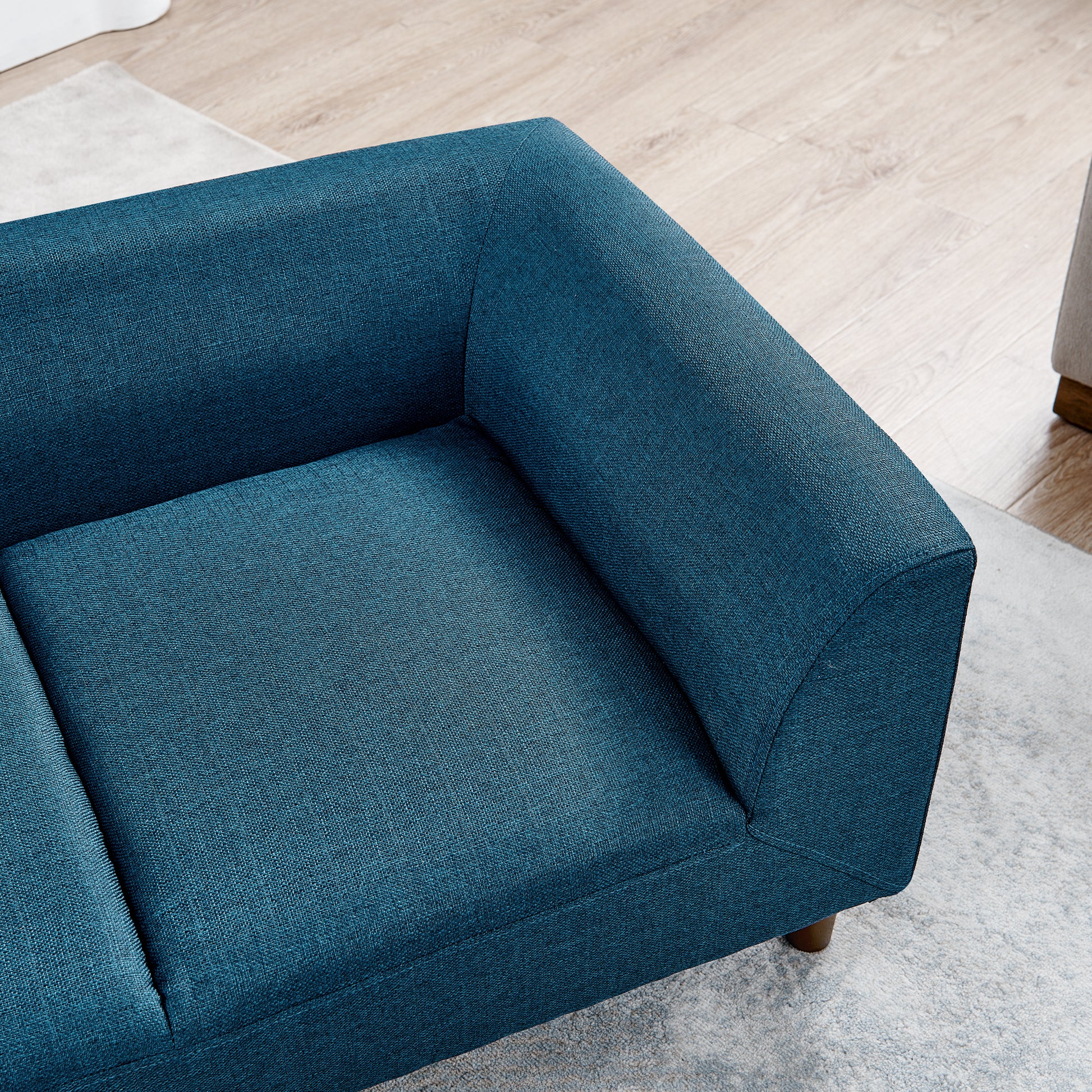 Teal fabric sofa corner with clean lines perfect for modern living rooms