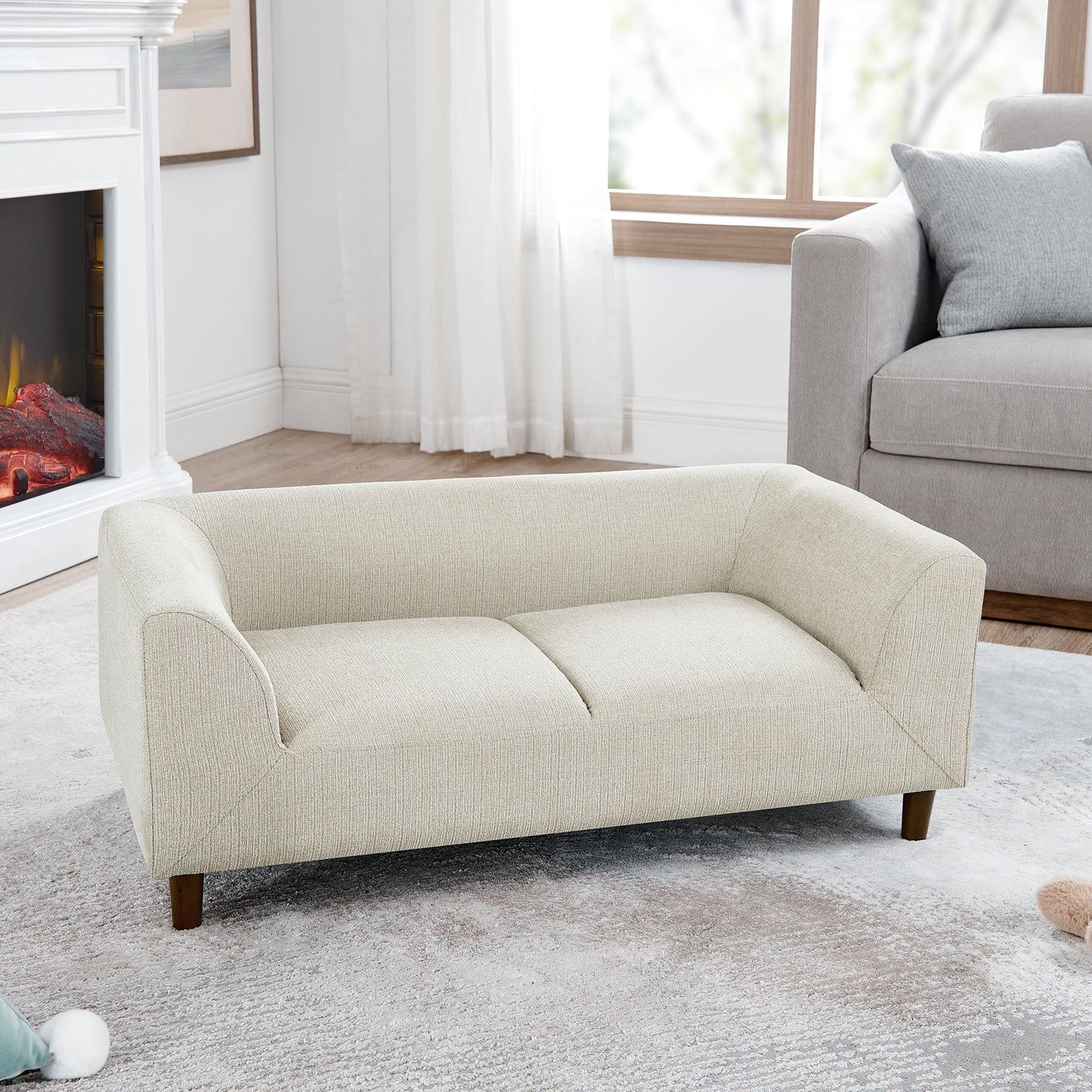 Cream textured fabric sofa with wooden legs perfect for a living room
