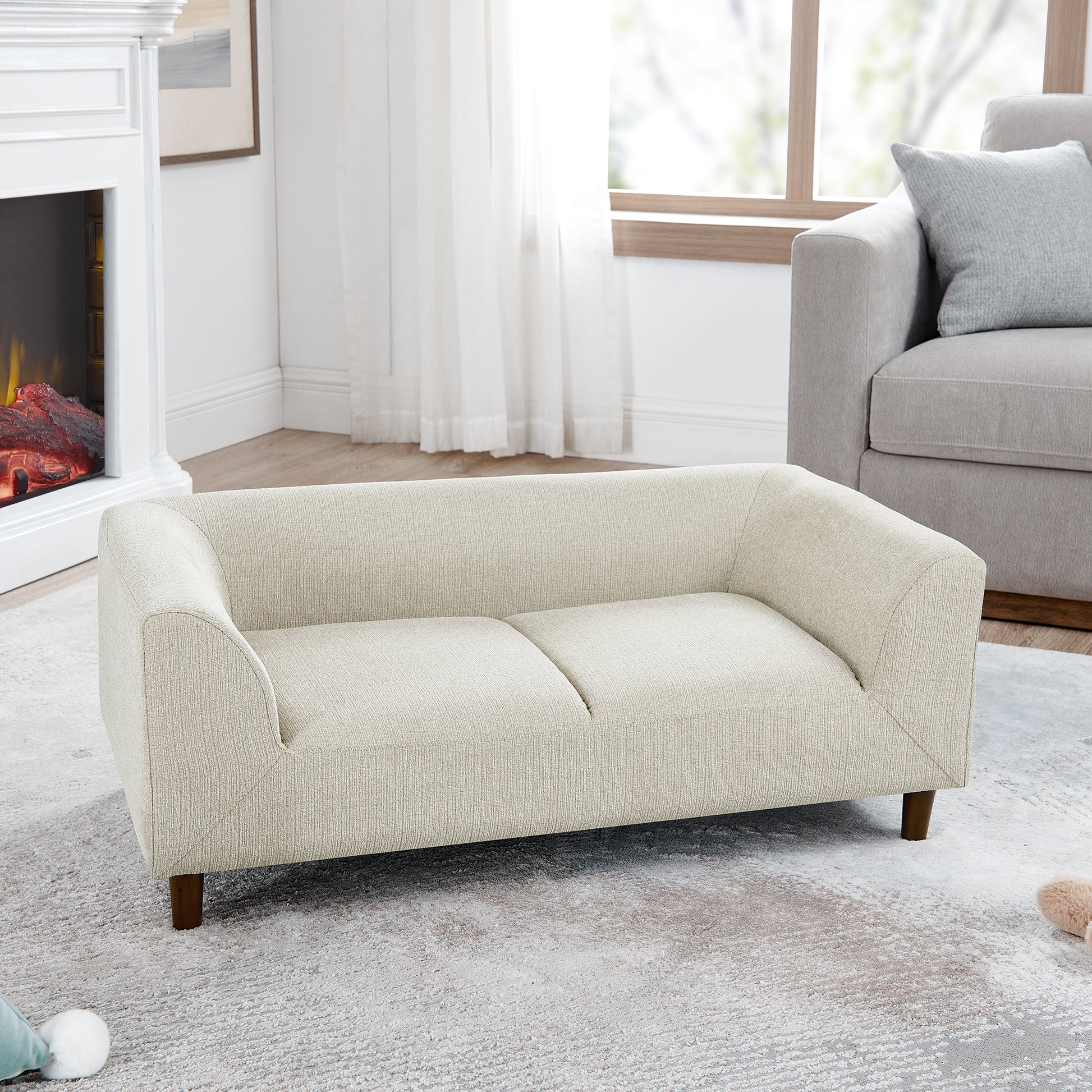 Cream textured fabric sofa with wooden legs perfect for a living room