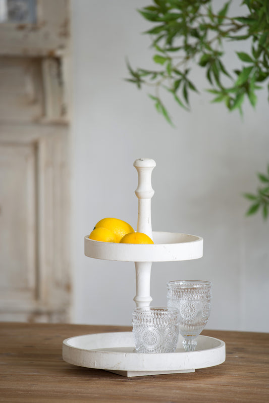 Distressed white tiered serving tray with lemons and clear embossed glasses