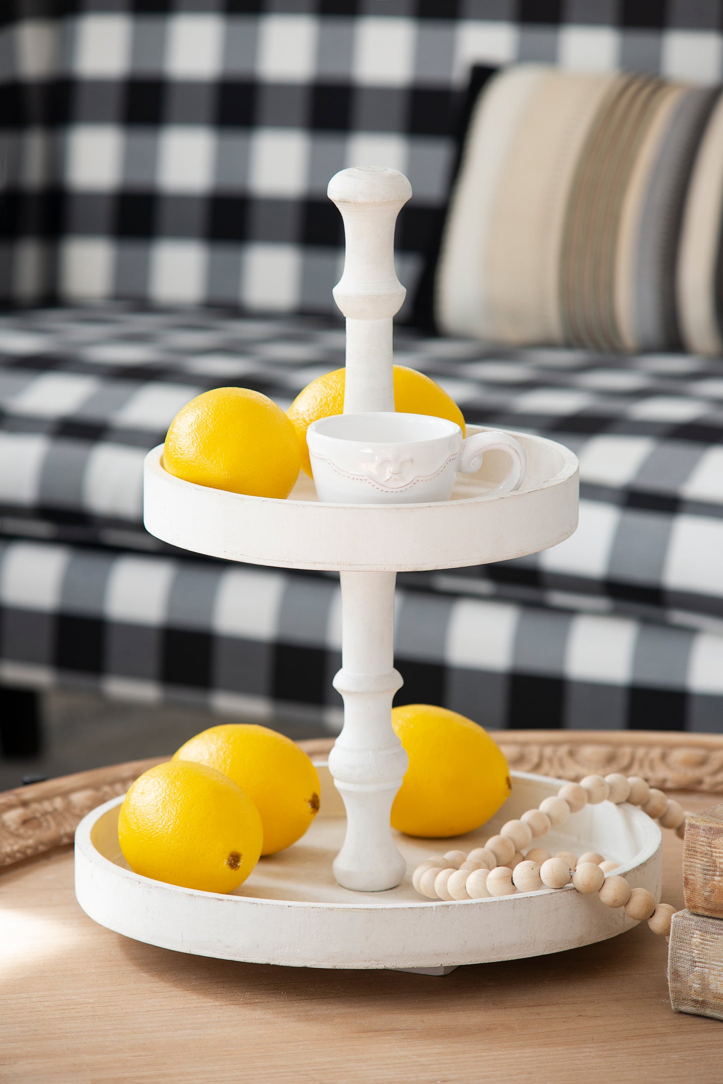 White tiered tray with lemons and beaded garland for farmhouse decor
