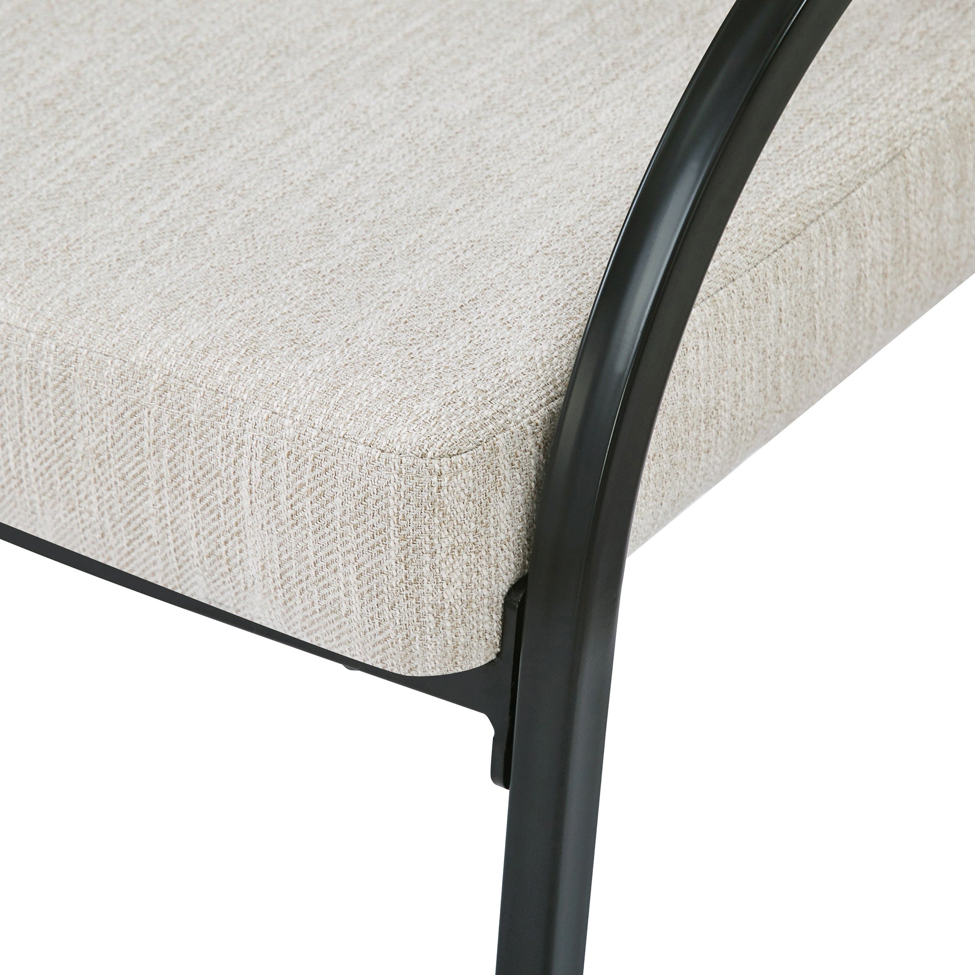 Close up of textured beige fabric seat cushion on a black metal chair frame