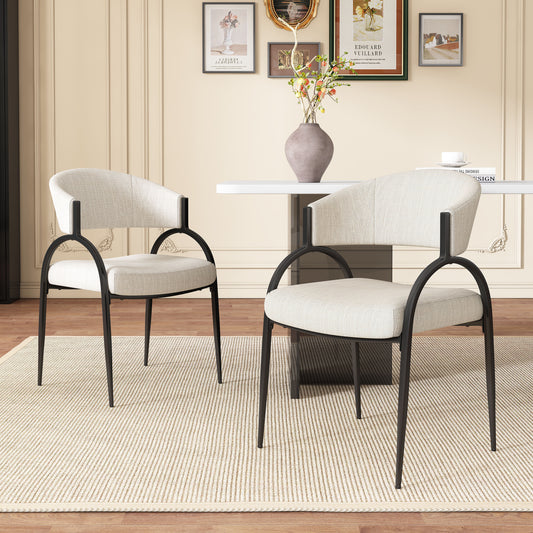 Two modern upholstered dining chairs with black metal frames and light beige fabric seats