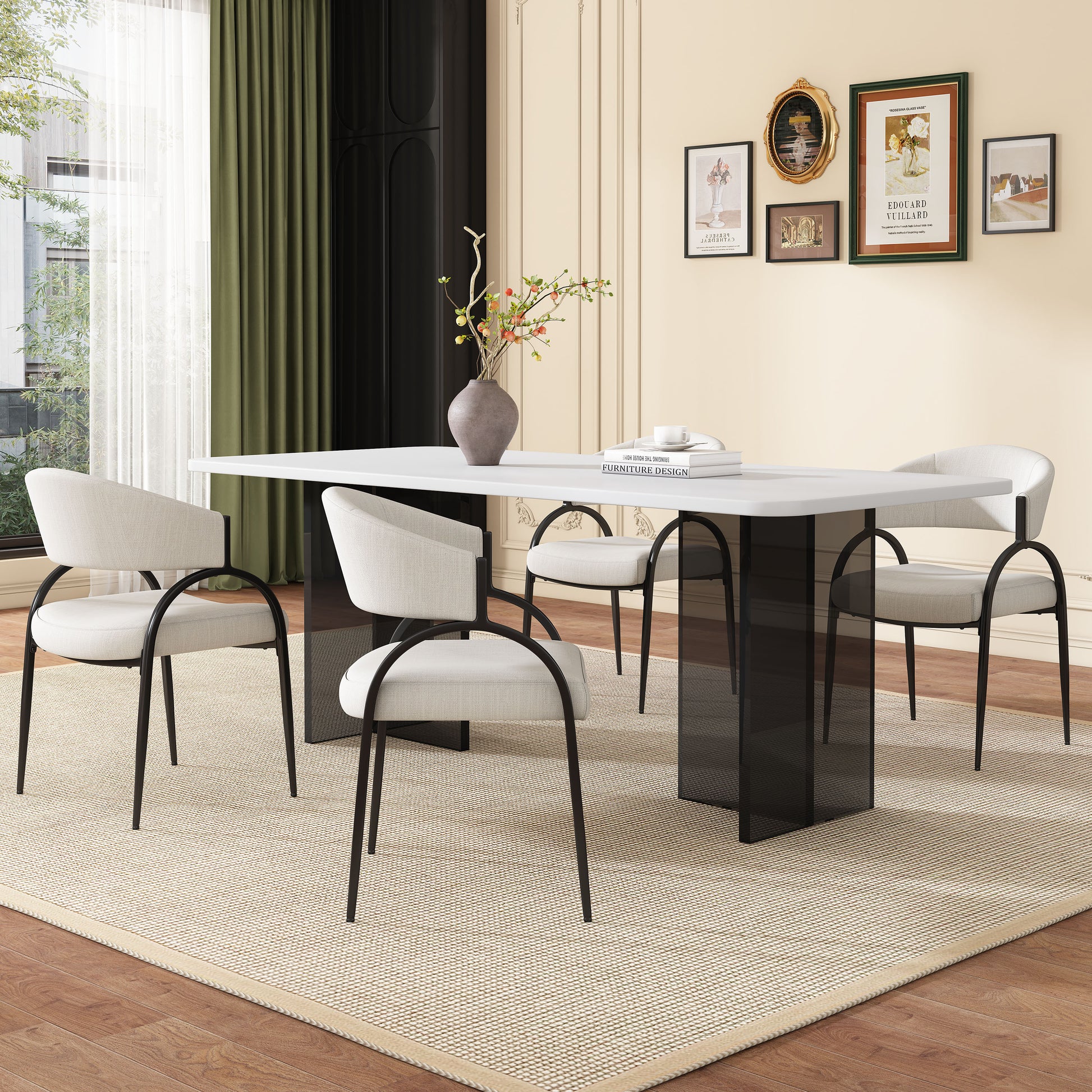 Modern white dining table with sleek black legs paired with four upholstered chairs