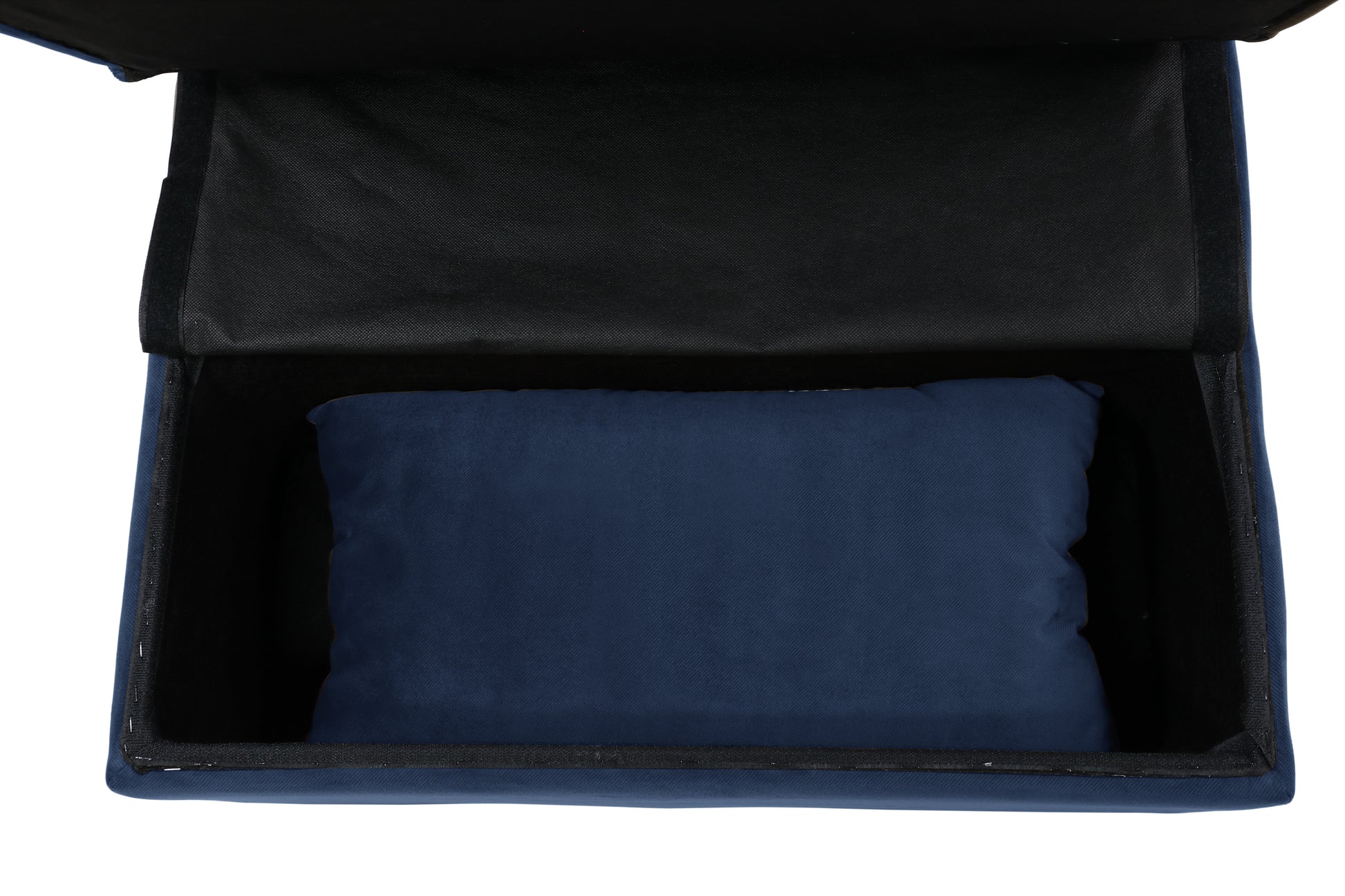 Navy blue velvet storage ottoman with a dark fabric interior and a lumbar pillow