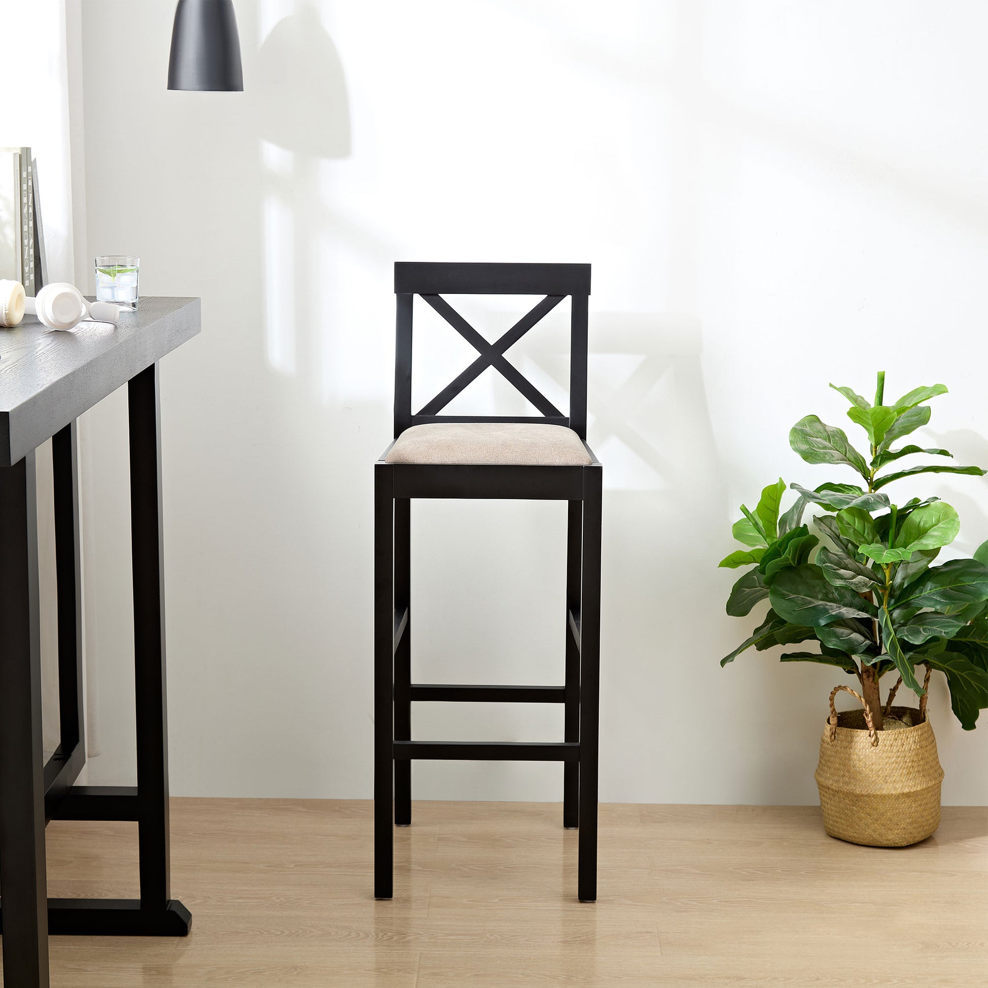 Black wooden bar stool with upholstered seat and Xback detail