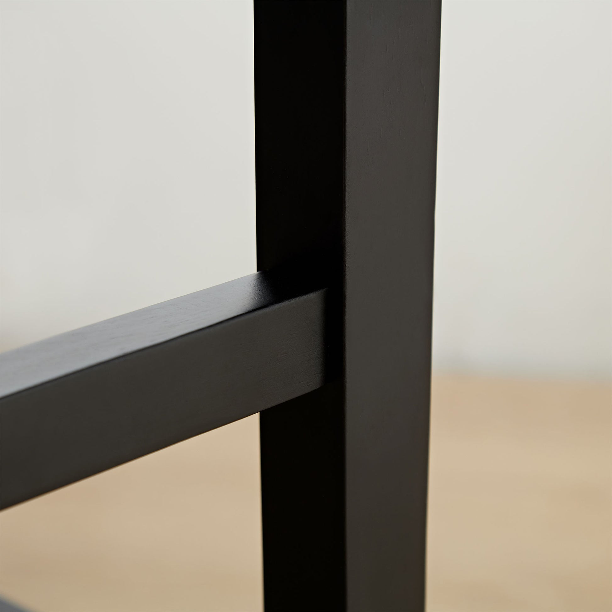 Closeup of matte black metal furniture leg joint