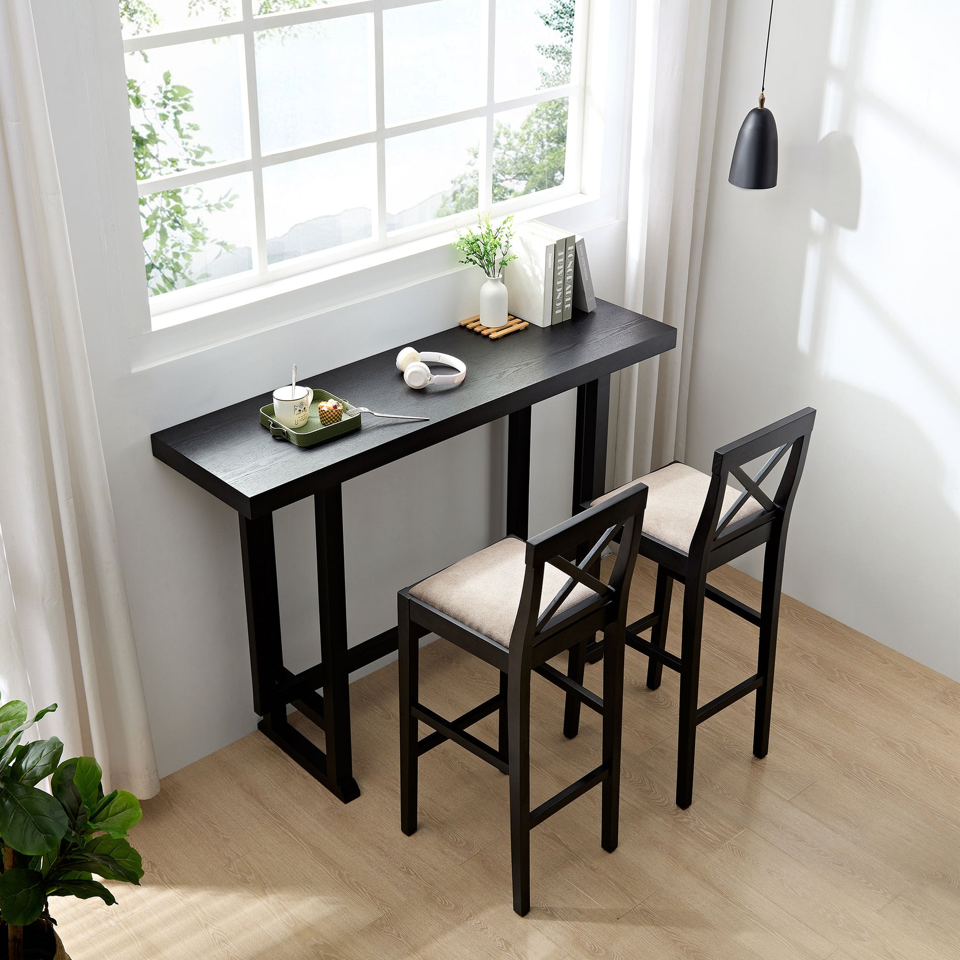 Black wood bar table with two beige cushioned stools