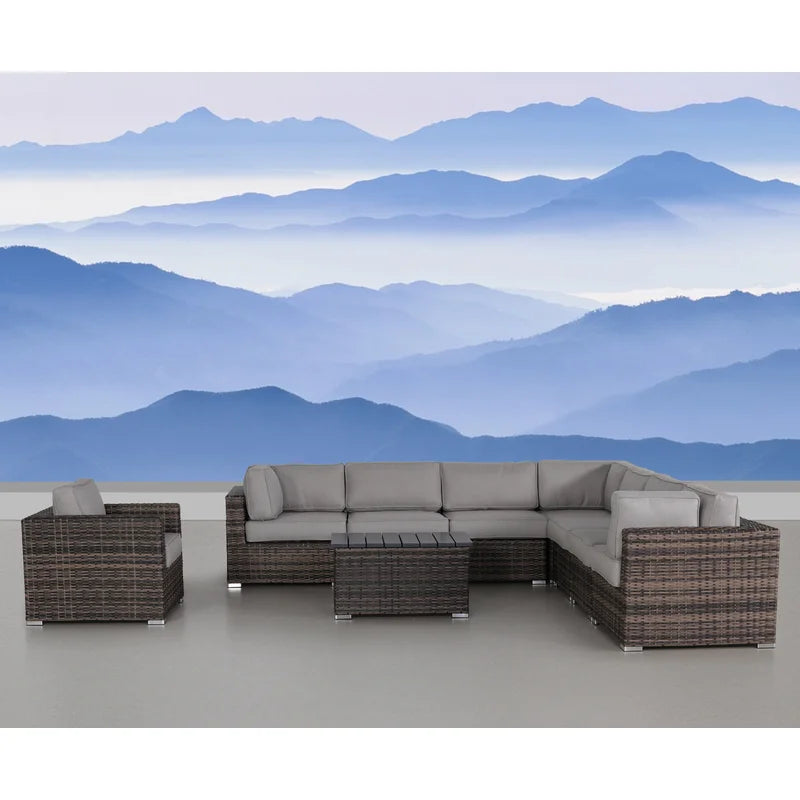 Wicker sectional sofa with grey cushions and matching coffee table on a patio