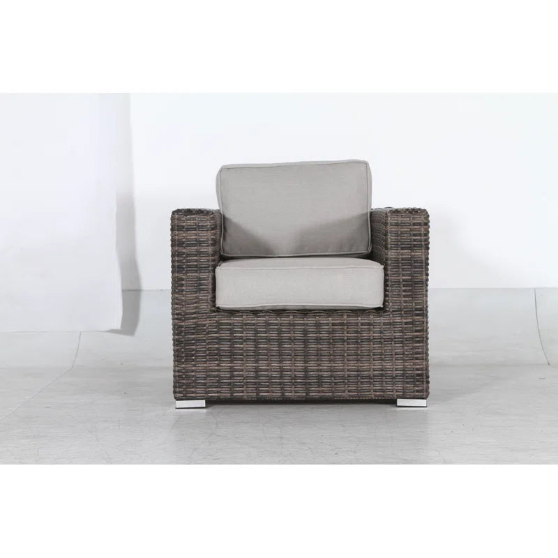 Brown wicker armchair with plush grey cushions perfect for outdoor patio relaxation