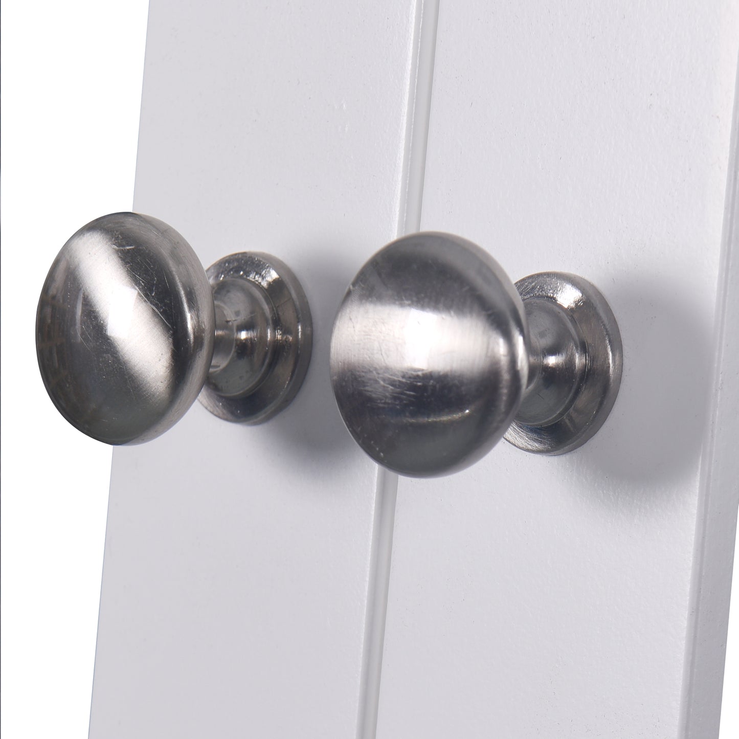 Pair of brushed nickel round door knobs on a white door