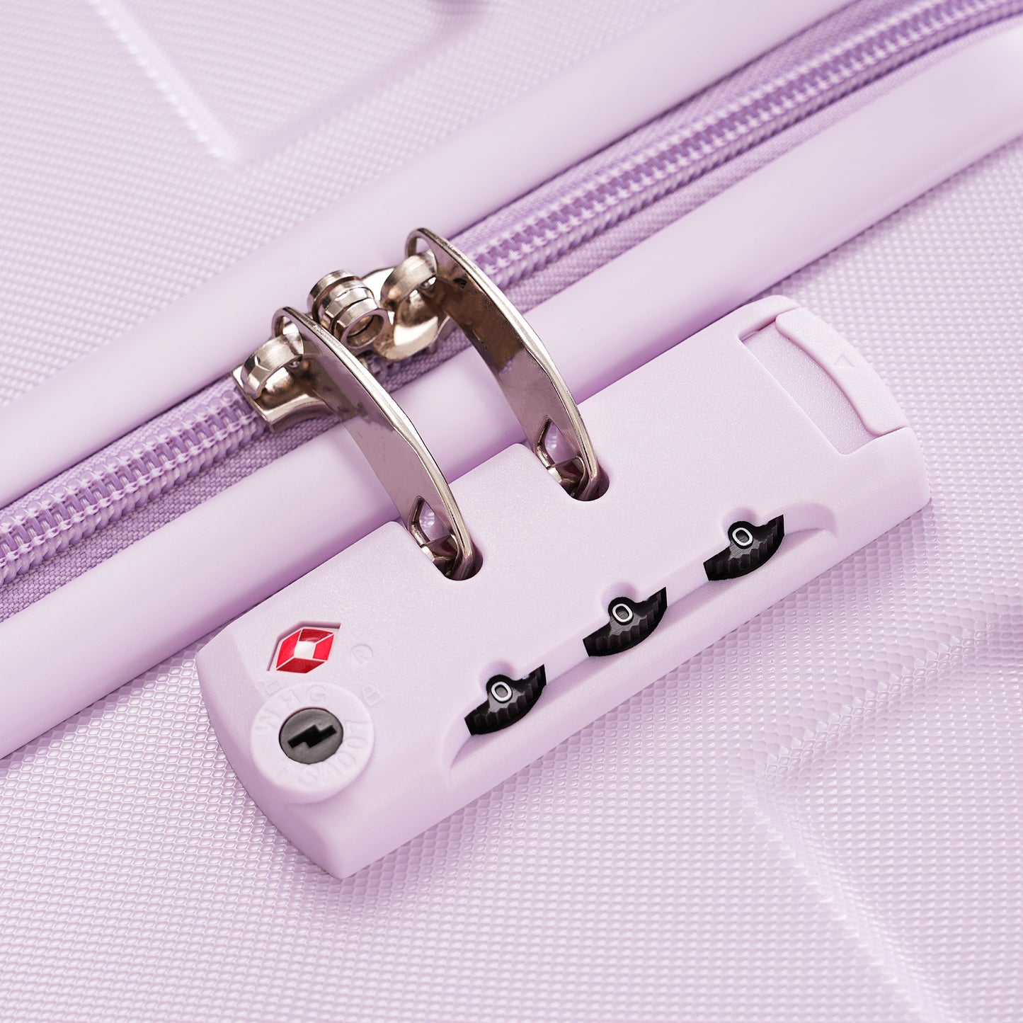 Closeup of a lavender luggage combination lock with TSA approval badge