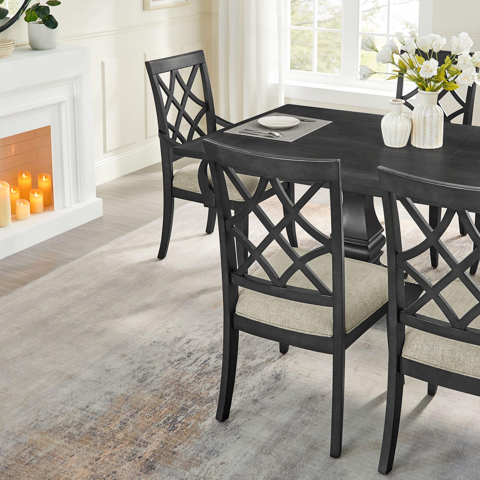 Dark gray wooden dining chairs with lattice backs and beige upholstered seats