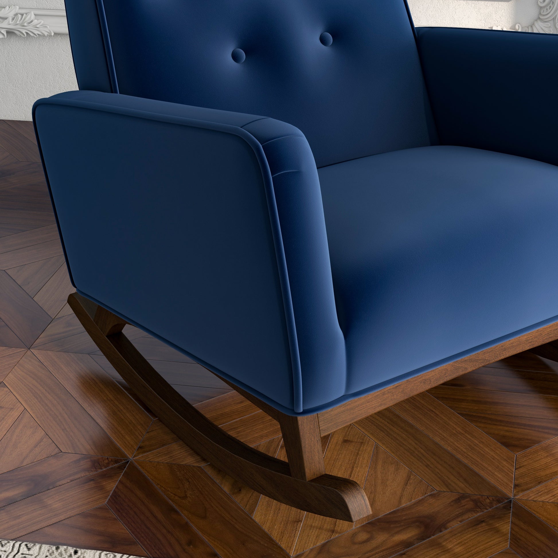 Deep blue velvet tufted rocking chair with a wooden base perfect for a nursery