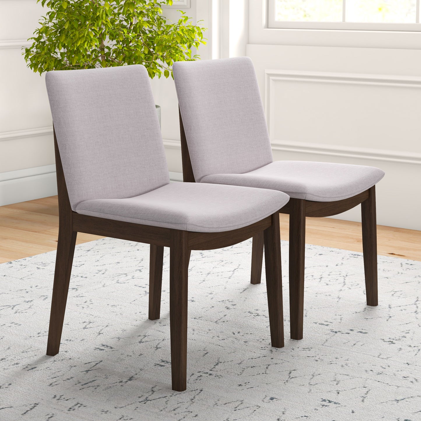 Two modern dining chairs with upholstered light grey seats and dark wood frames