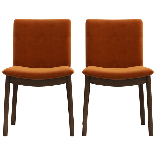 Two burnt orange velvet dining chairs with dark wood legs