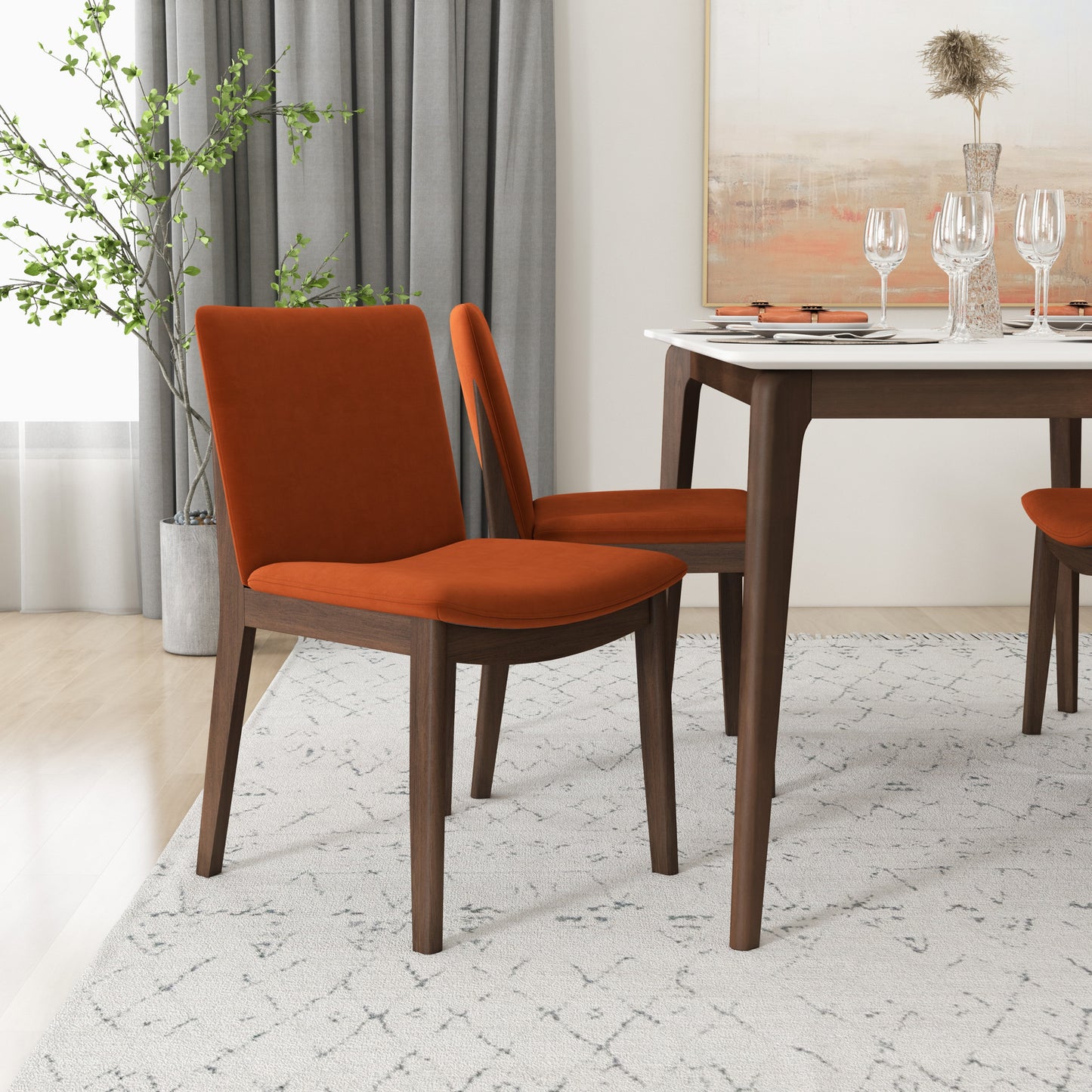 Armless orange velvet dining chair with dark wood frame