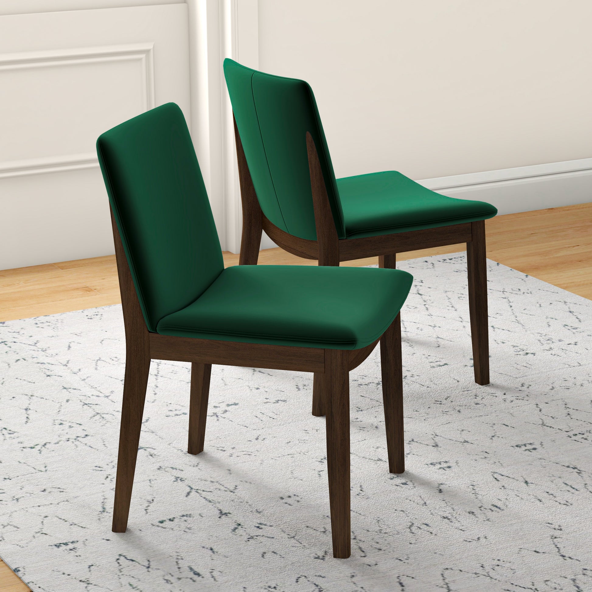 Emerald green velvet dining chair with dark wood legs