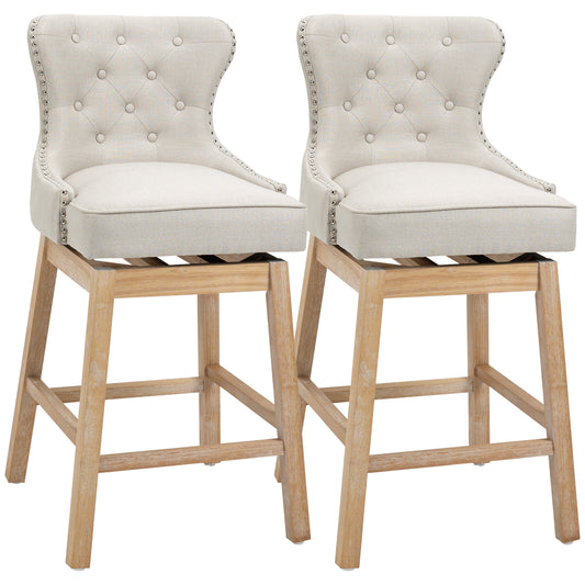 Tufted beige fabric swivel bar stool with nailhead trim and light wood legs
