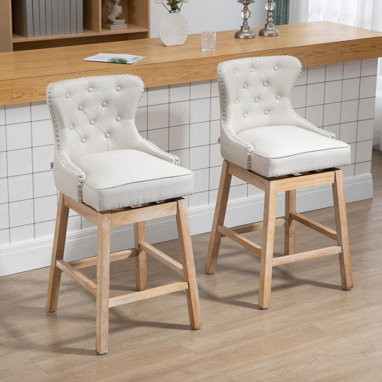 Cream tufted linen bar stool with silver nailhead trim and light wood legs