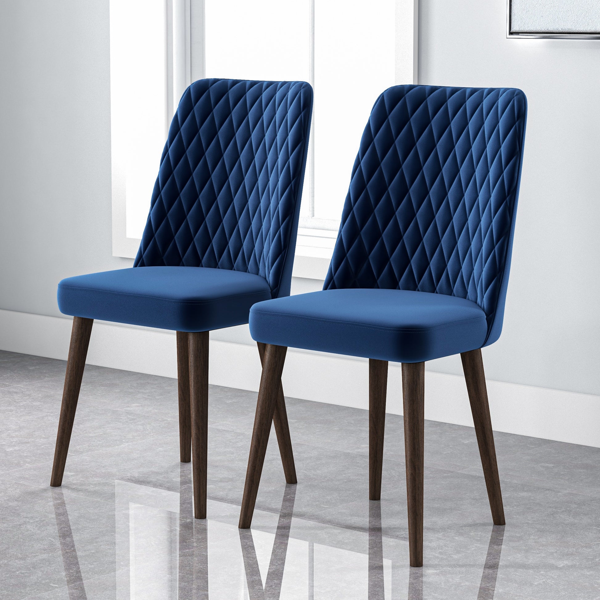 Two elegant navy blue velvet dining chairs with diamond tufting and dark wood legs