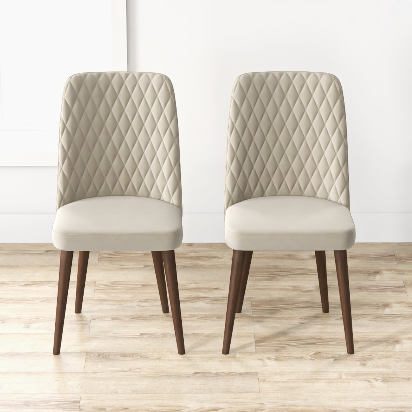 Two upholstered accent chairs with diamondstitched backs and tapered wooden legs