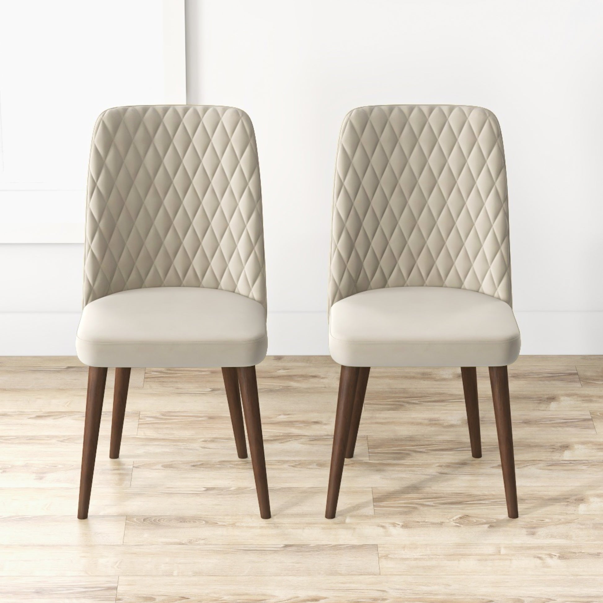 Two upholstered accent chairs with diamondstitched backs and tapered wooden legs