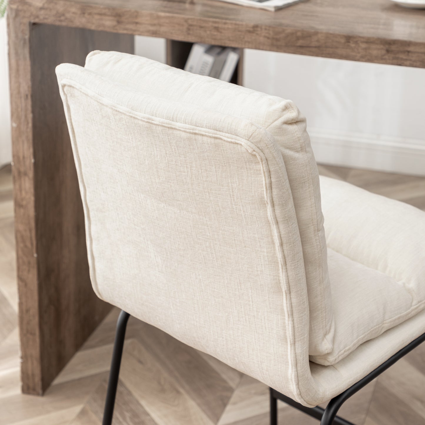 Textured cream upholstered dining chair with black metal legs offering modern comfort