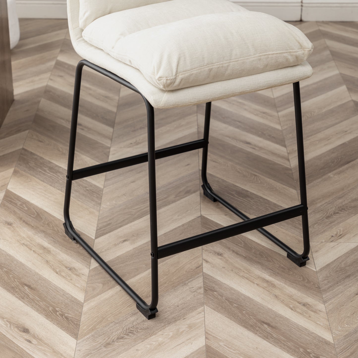 Cream upholstered bar stool with black metal legs ideal for kitchens