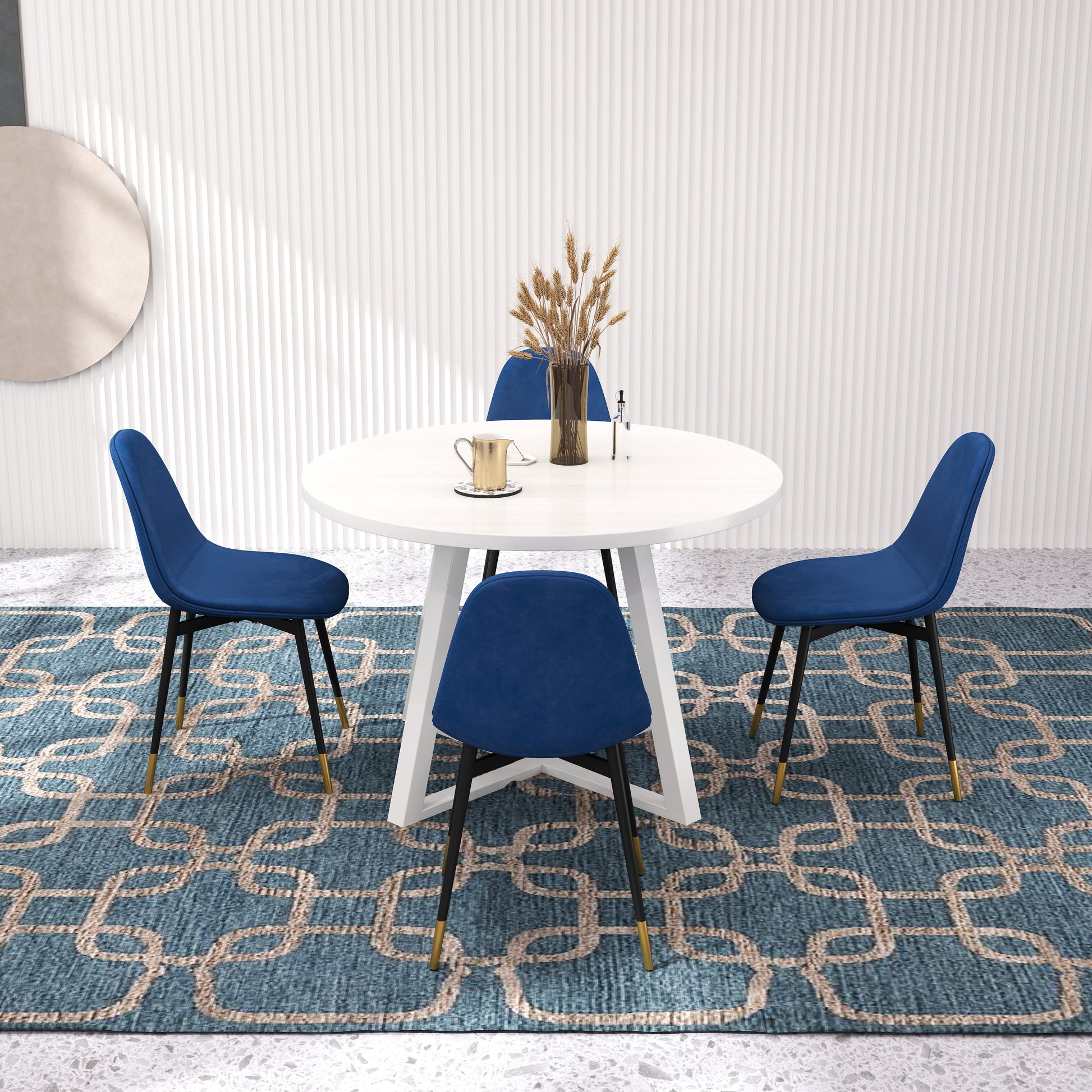Modern white round dining table with four plush blue chairs and ornate rug
