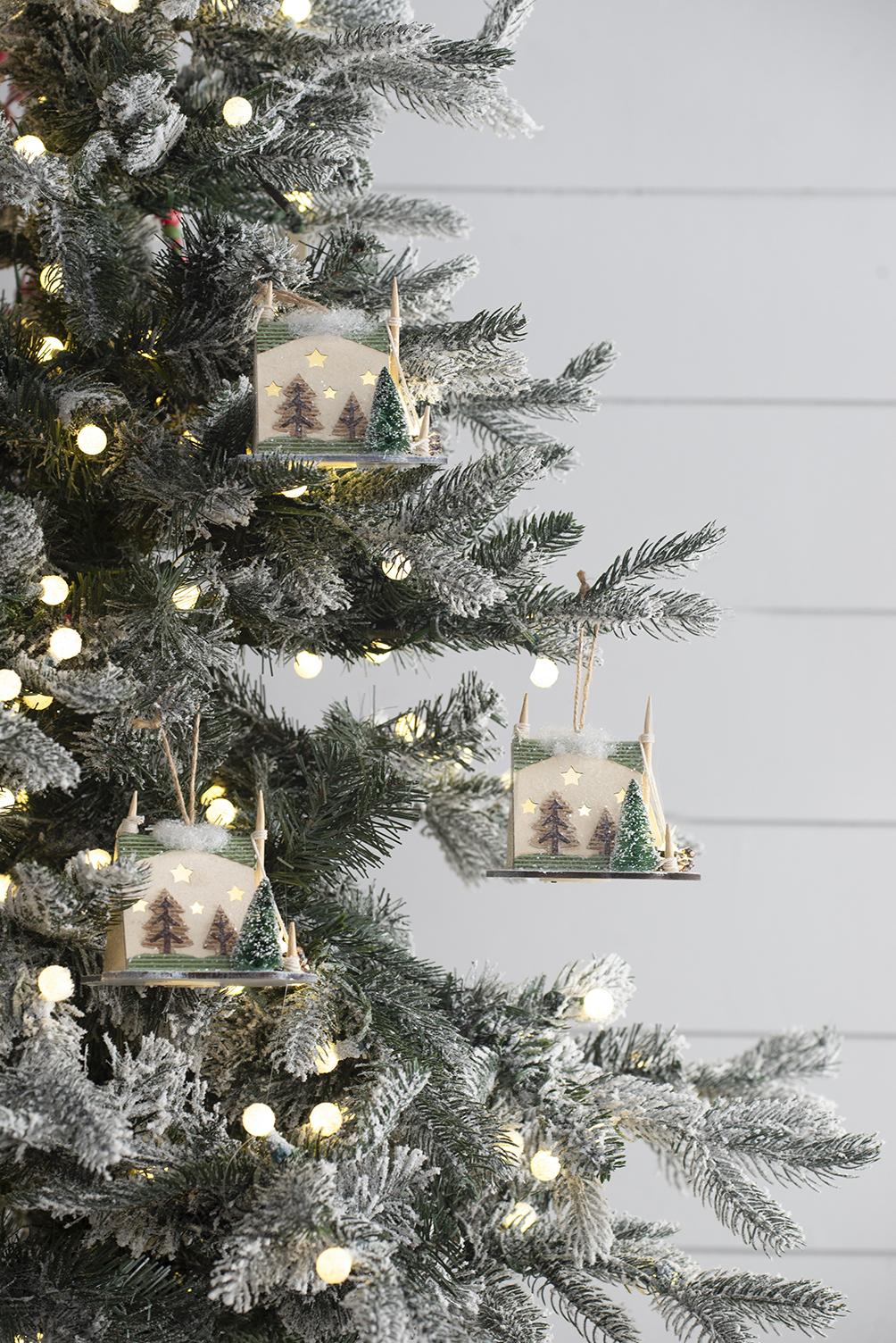 Wooden Christmas ornament with glowing stars and miniature trees
