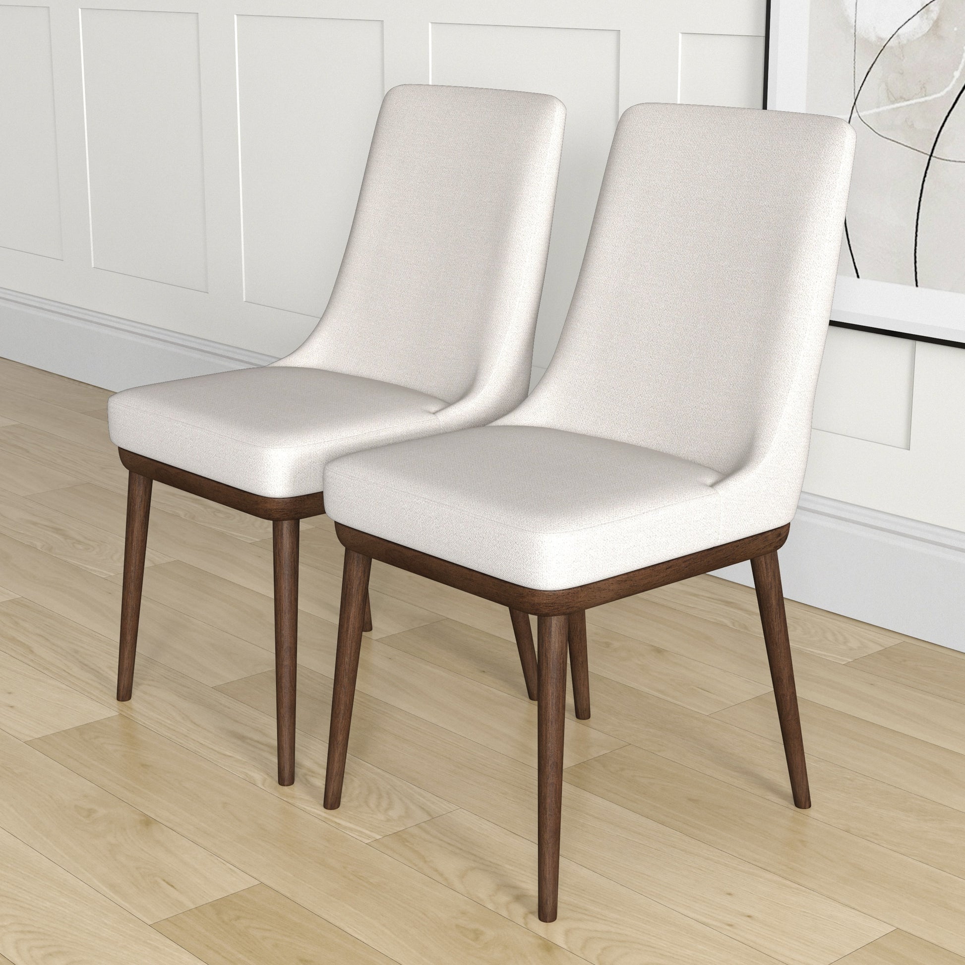Two light beige upholstered dining chairs with dark wood tapered legs