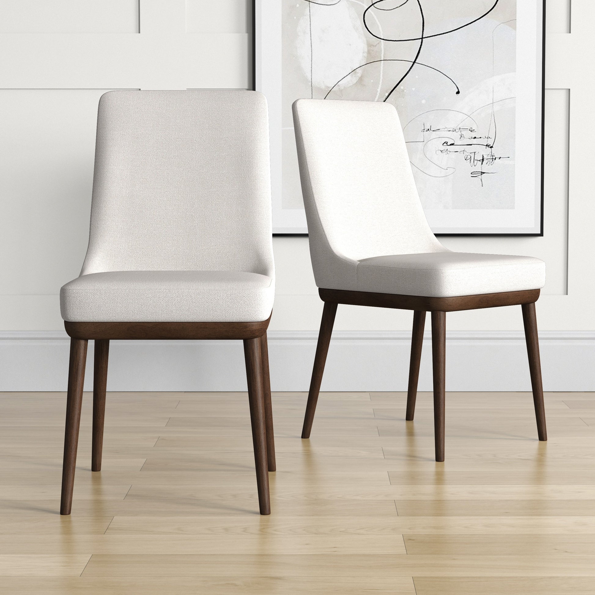Two upholstered dining chairs in cream white with dark wood legs