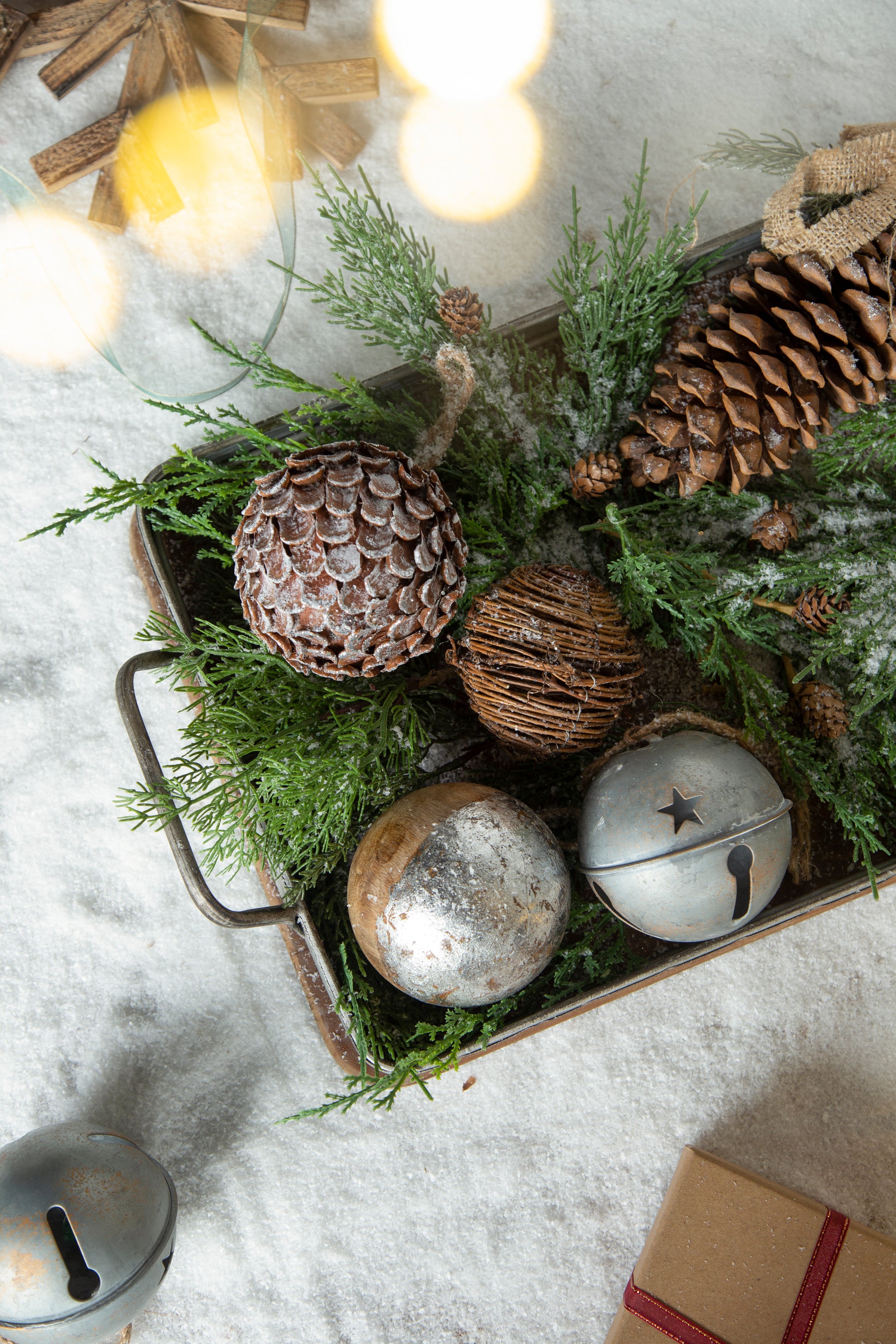 Rustic pine cone Christmas ornament with textured surface and flocked snow