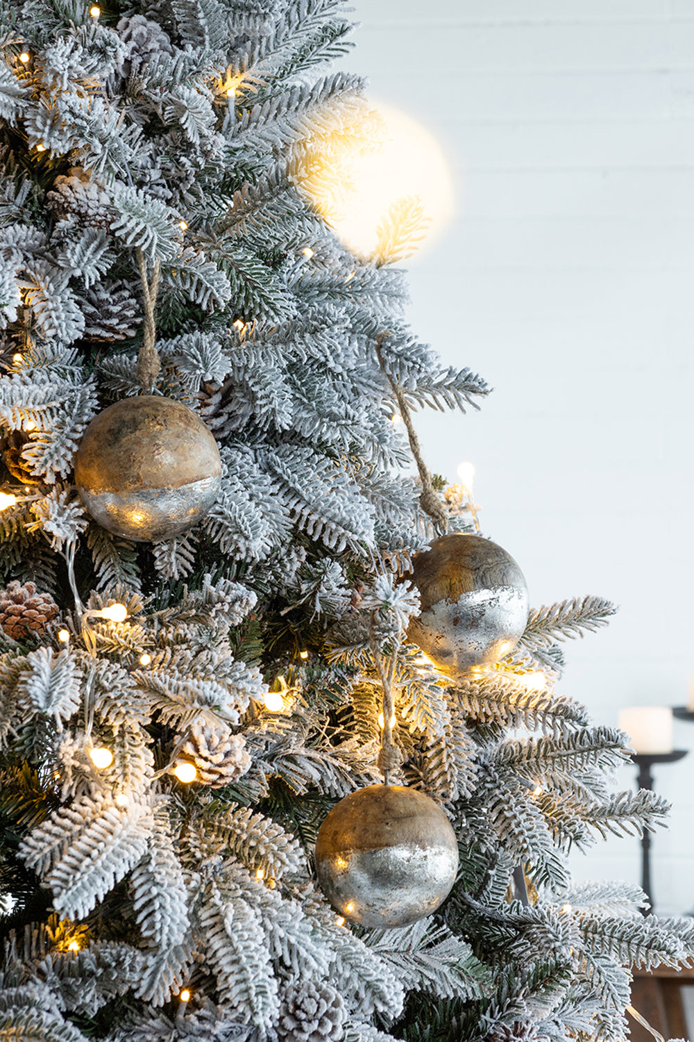 Flocked pine needles and rustic metallic christmas ornaments with twine
