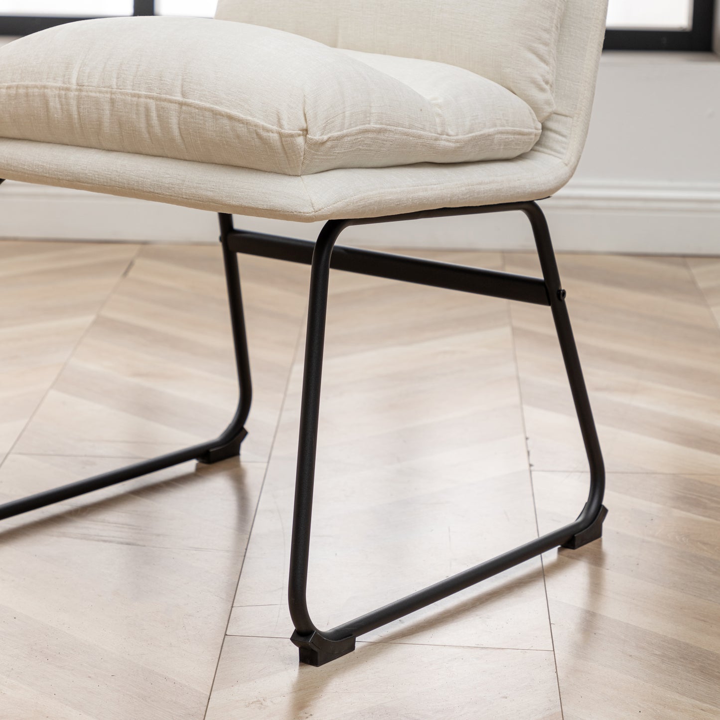 Offwhite textured fabric dining chair with matte black metal legs