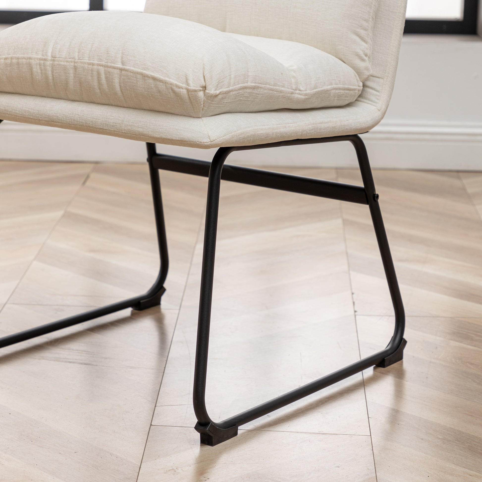 Offwhite textured fabric dining chair with matte black metal legs