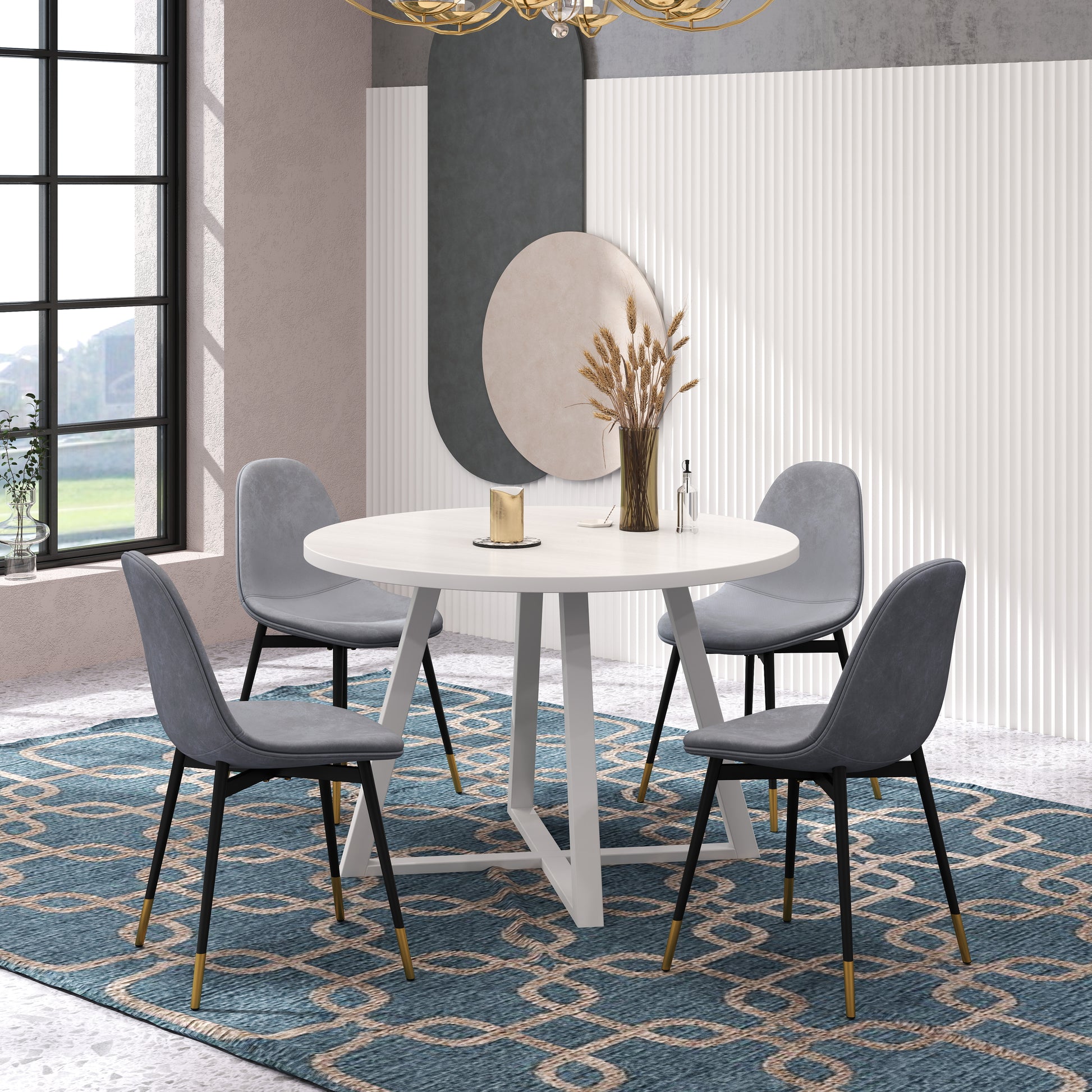 Round white dining table with four grey chairs and modern gold accents