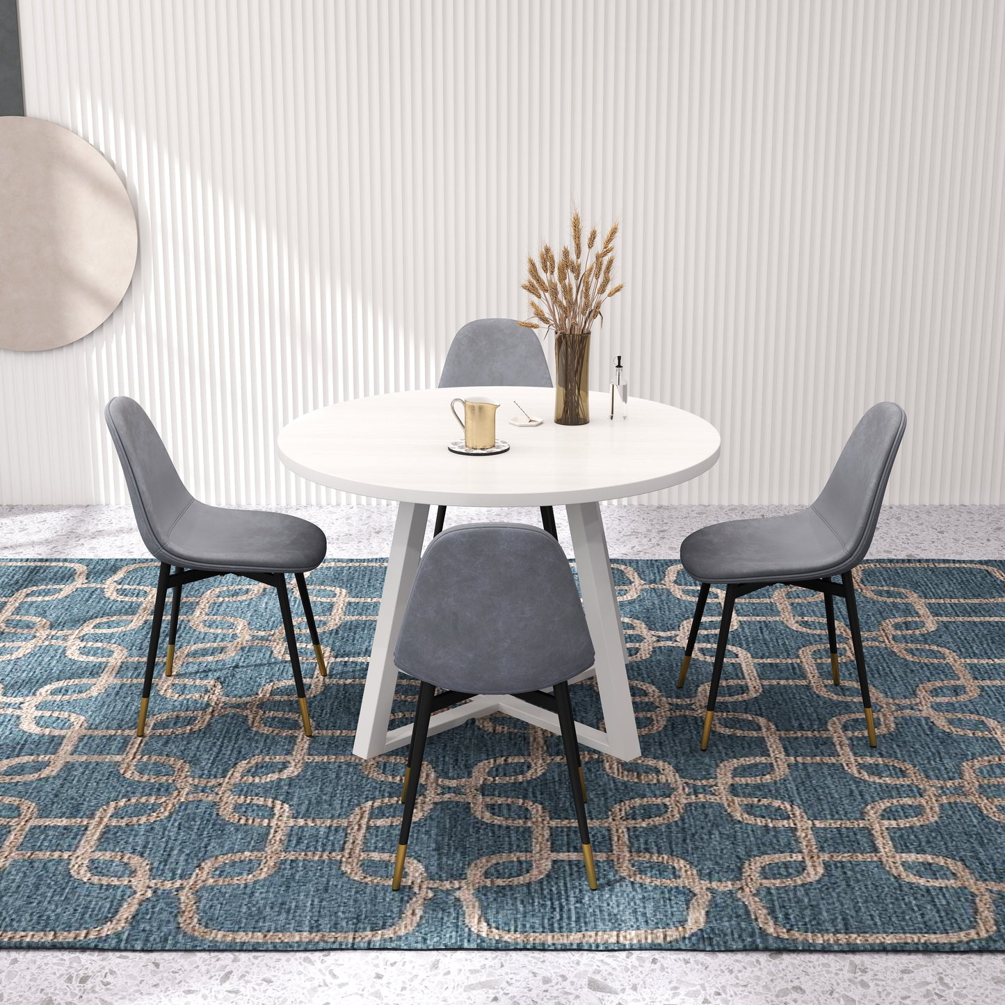 White round dining table with four grey upholstered chairs around it
