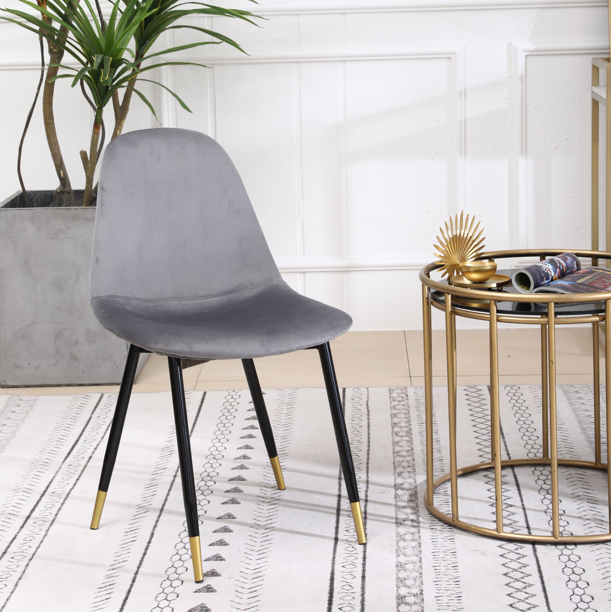 Grey velvet dining chair with black and gold legs