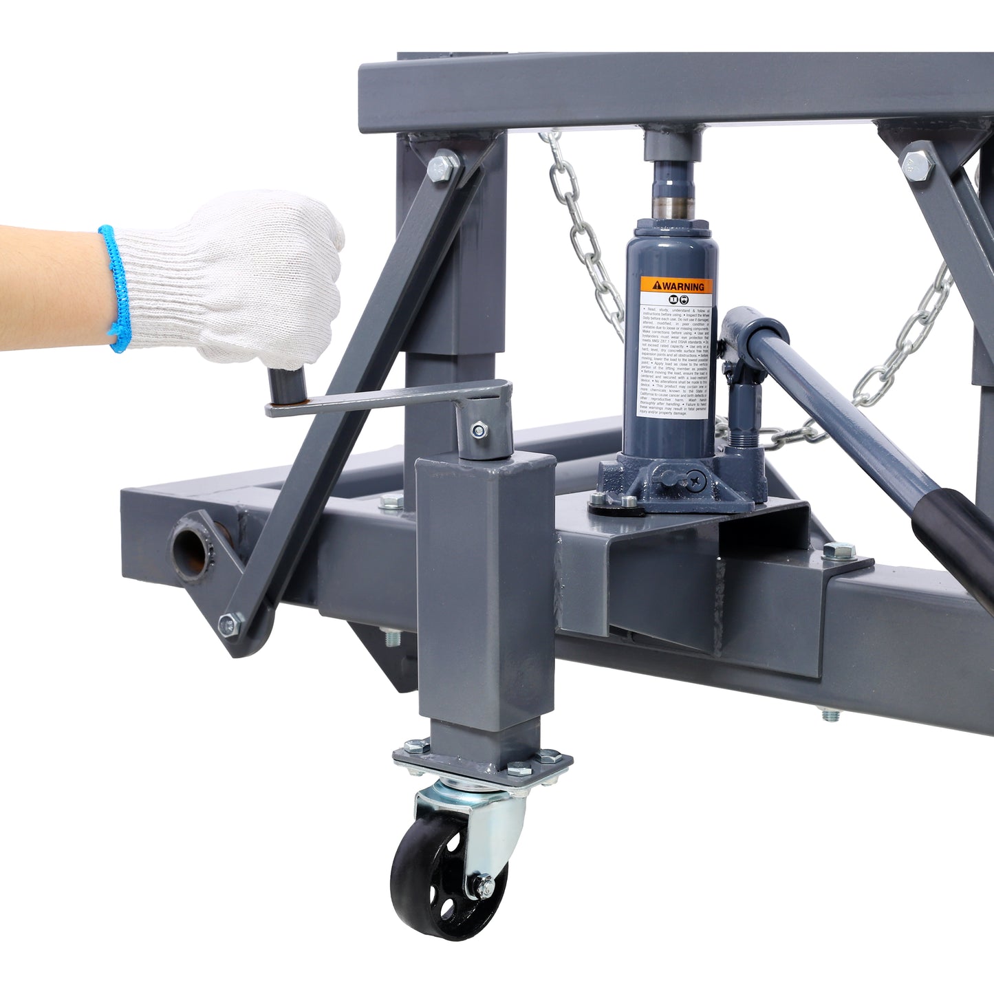 Closeup of a gloved hand operating the crank on a heavyduty gray hydraulic floor jack