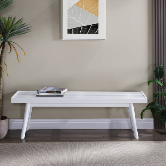 White slatted bench with angled legs holding a stack of books