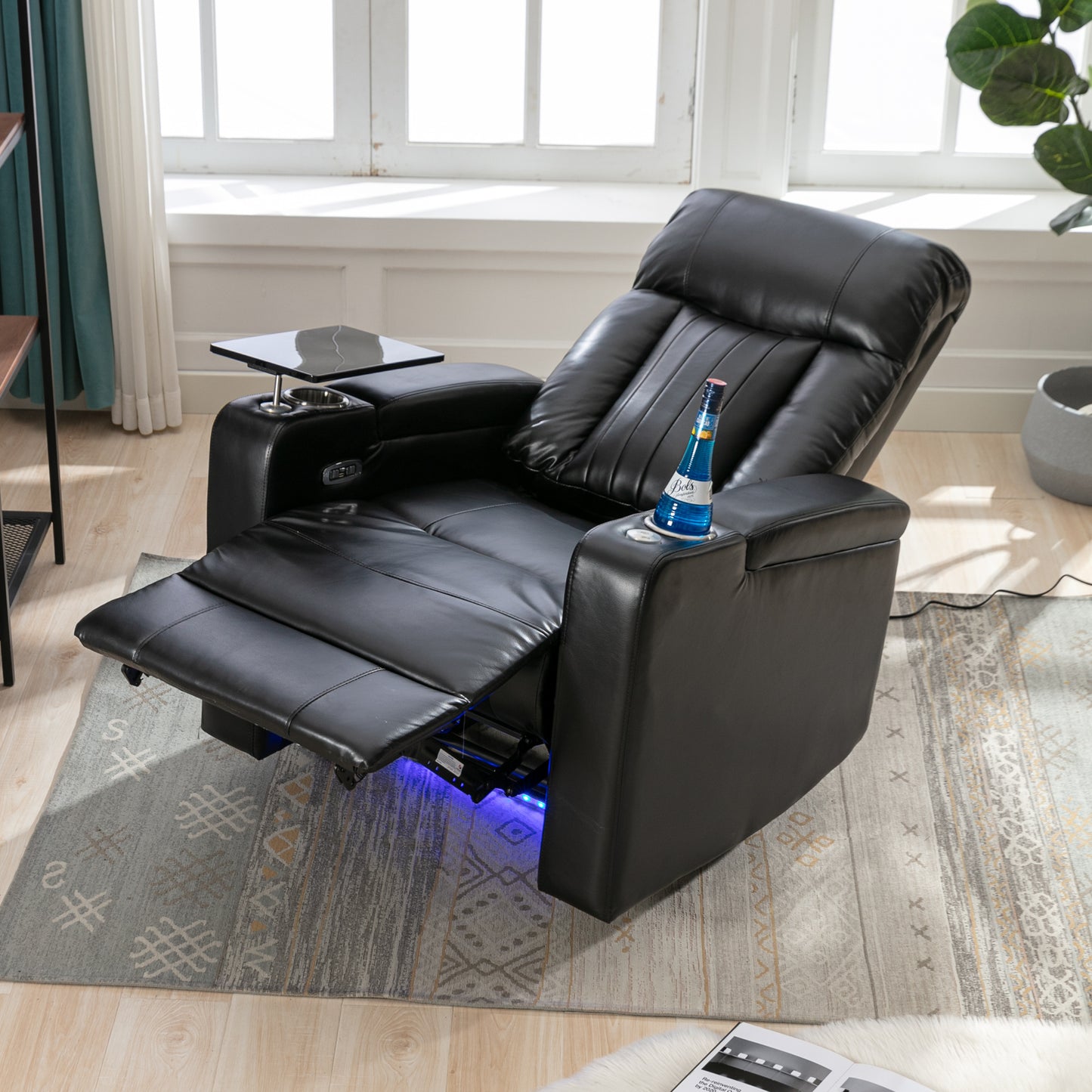 Black leather power recliner with builtin tray table and cup holders perfect for home theater