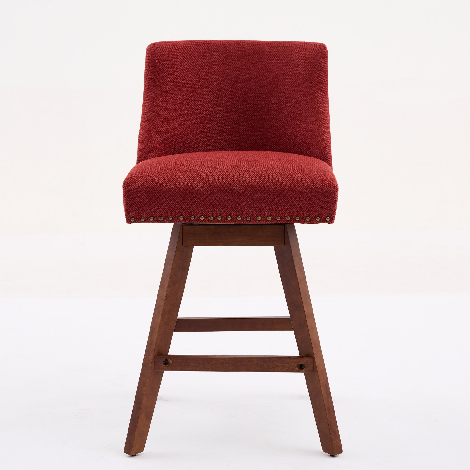 Red upholstered swivel bar stool with wooden base and nailhead trim