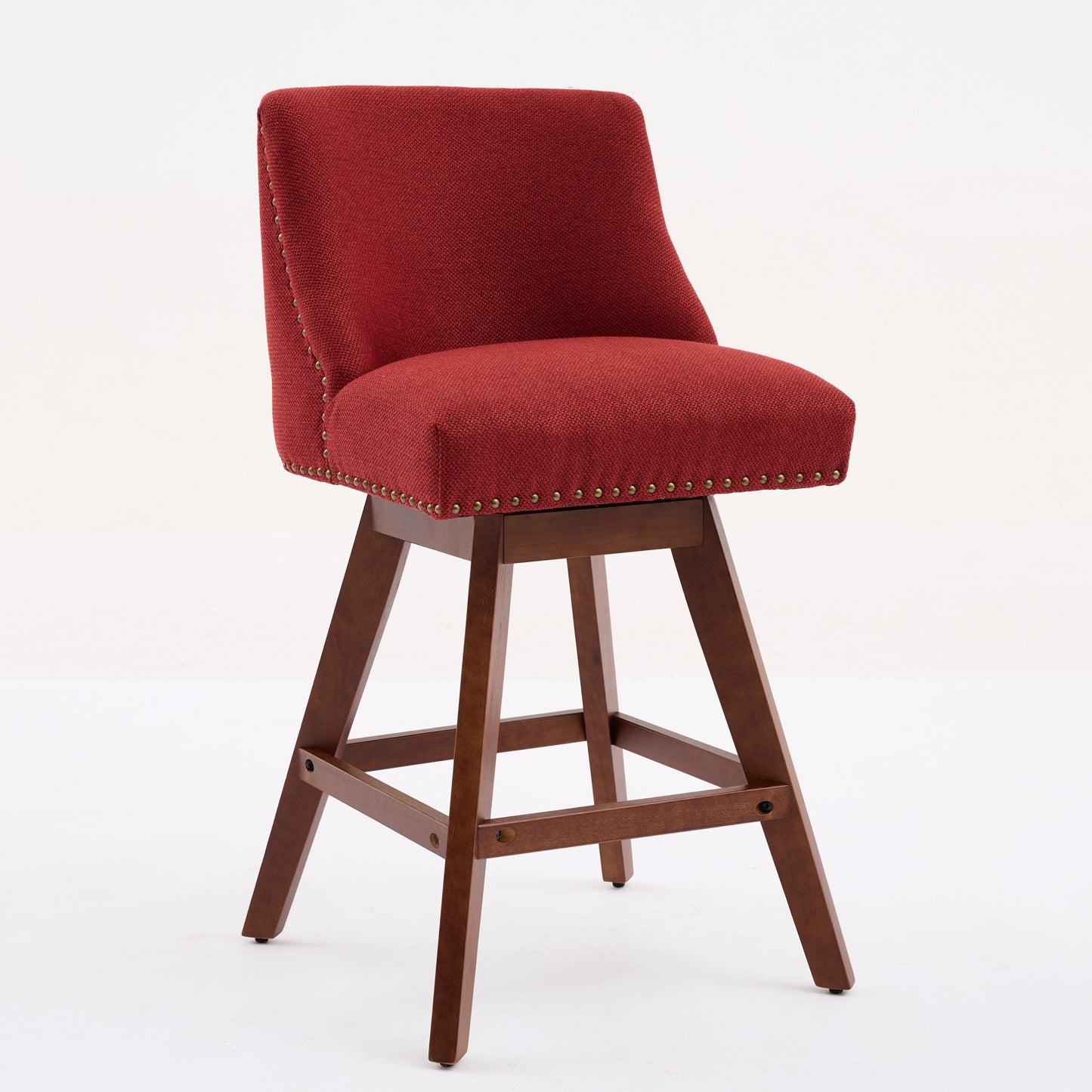 Red upholstered swivel bar stool with brass nailhead trim and wooden legs