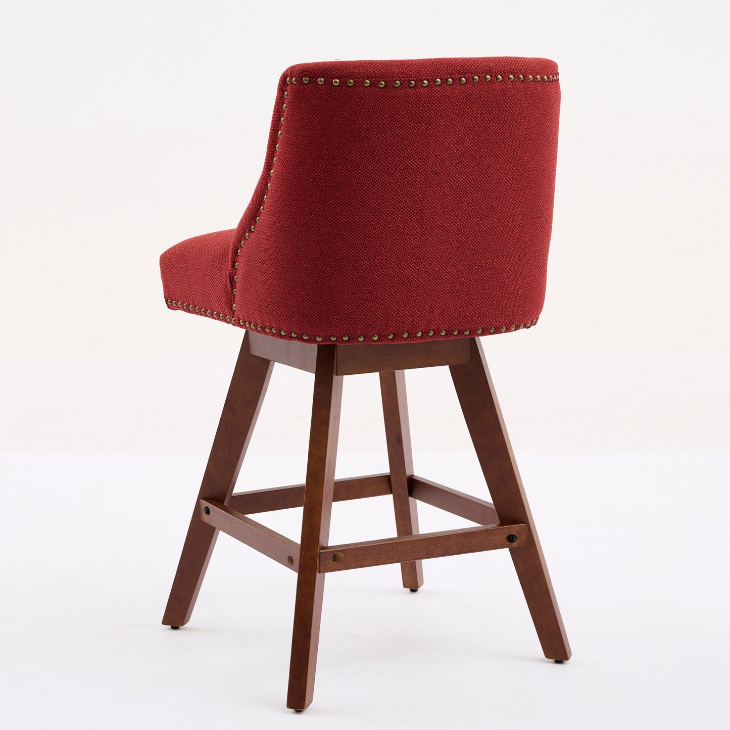 Red upholstered swivel bar stool with bronze nailhead trim and wood legs