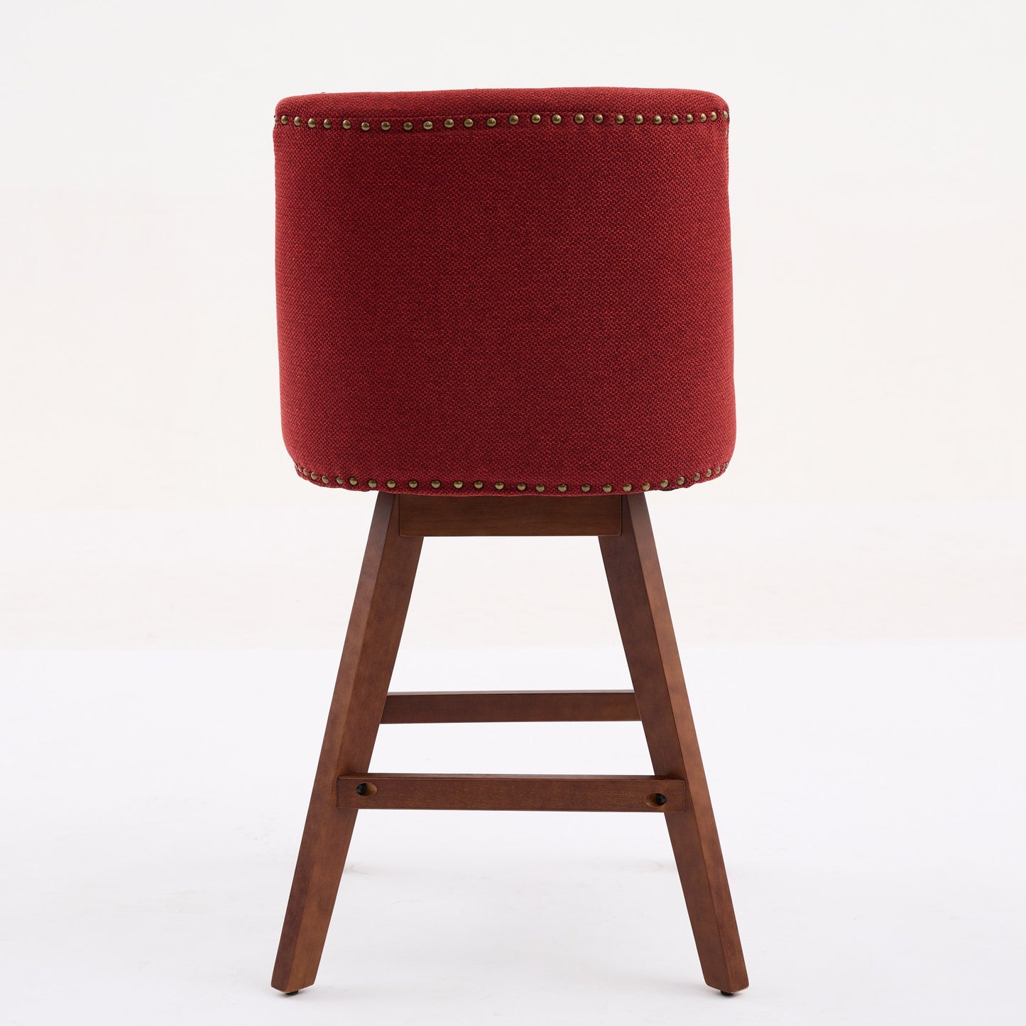 Deep red upholstered bar stool with nailhead trim and a wooden base