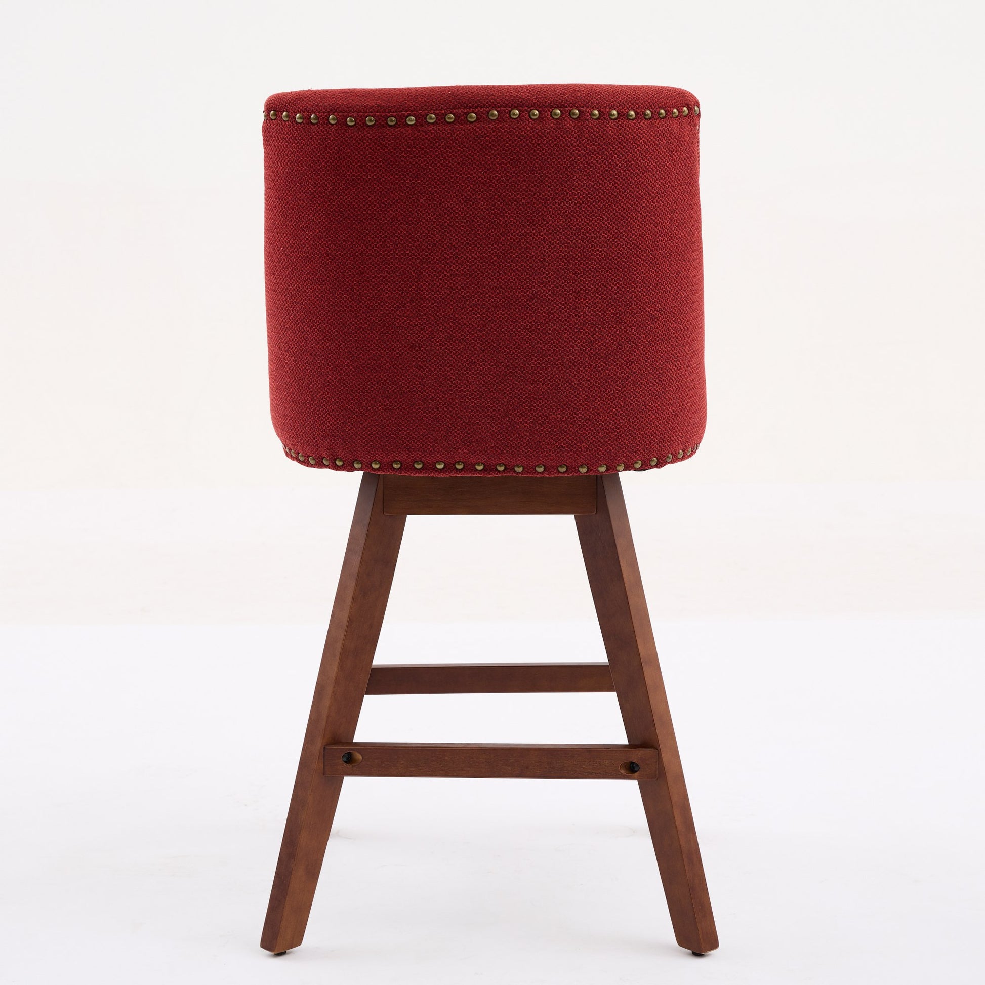 Deep red upholstered bar stool with nailhead trim and a wooden base