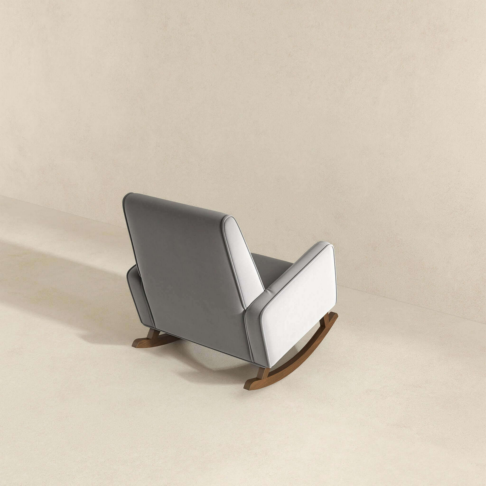 Gray upholstered rocking chair with wood base perfect for nurseries and living rooms
