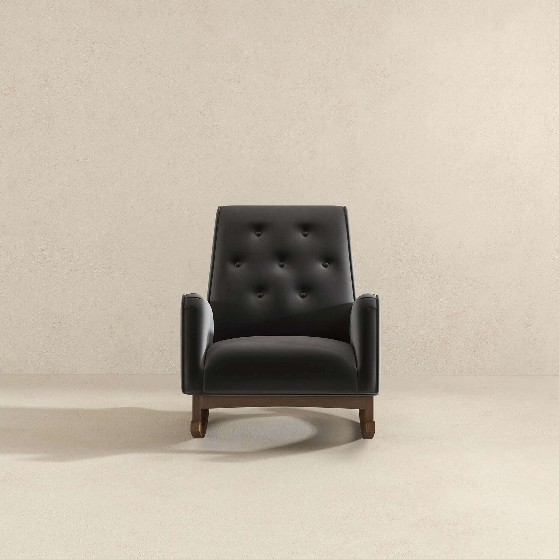 Dark charcoal velvet armchair with button tufting and wooden legs
